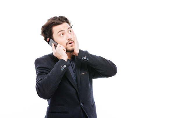 Thoughtful businessman talking on the phone - Фото, зображення