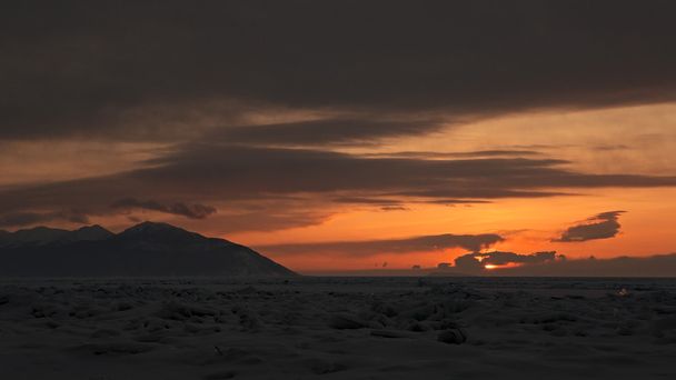 Sunset on a background of the Holy Nose Peninsula. - Фото, изображение
