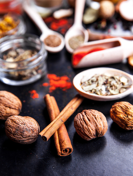 Spices on black background in special jars. Food - Foto, Bild