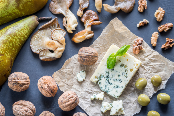 Blue cheese with walnuts, oyster mushrooms and green olives - Photo, Image