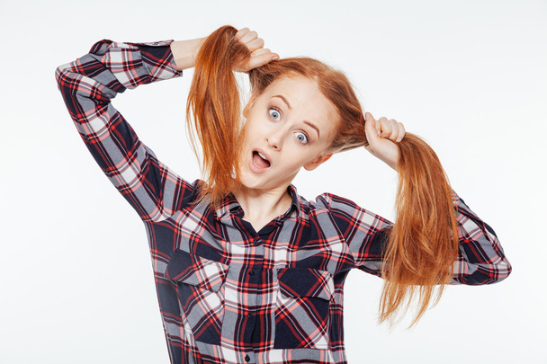 Redhead woman holding her ponytails - Foto, afbeelding