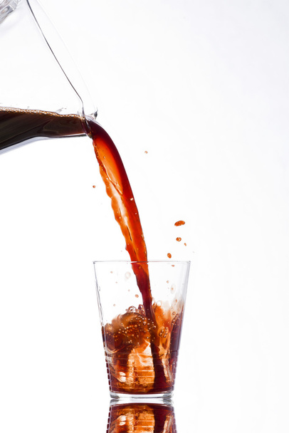 Drink poured from a jug into a glass - Fotografie, Obrázek