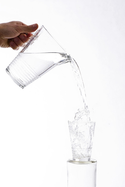 Poured water from a jug into a glass - Foto, Bild