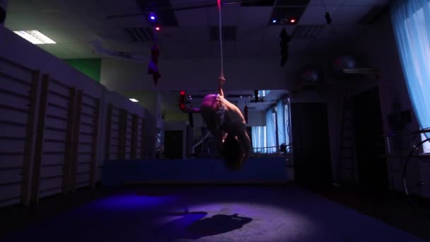 Aerial acrobat woman on circus stage. tricks hoop on a blue background - Footage, Video