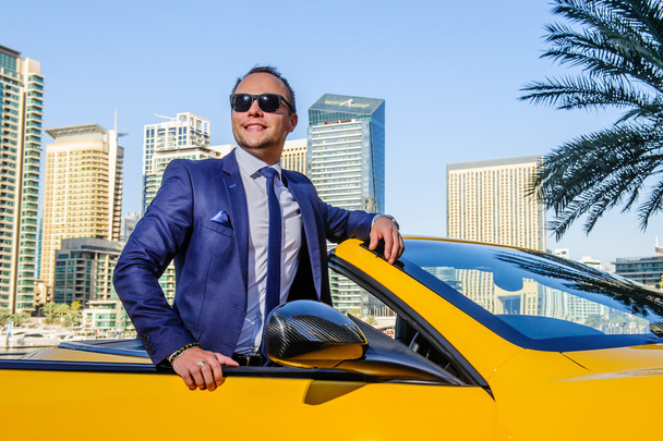 Successful yang businessman in yellow cabrio car. - Photo, Image