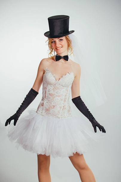 blonde bride in tophat with veil and long black gloves - Photo, image