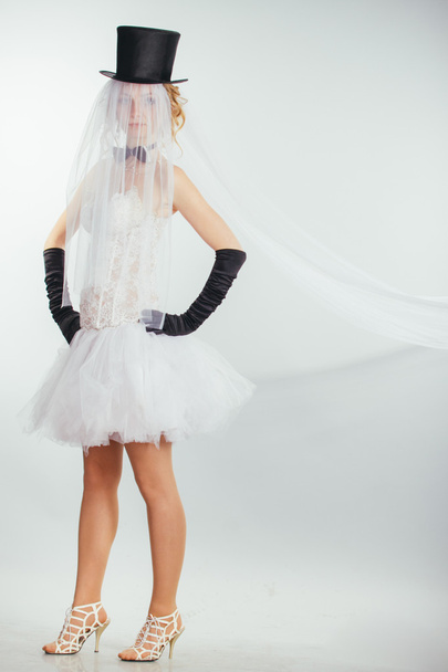 blonde bride in tophat with veil and long black gloves - Fotó, kép