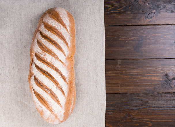 Leavened durum flour bread loaf on table - Фото, изображение