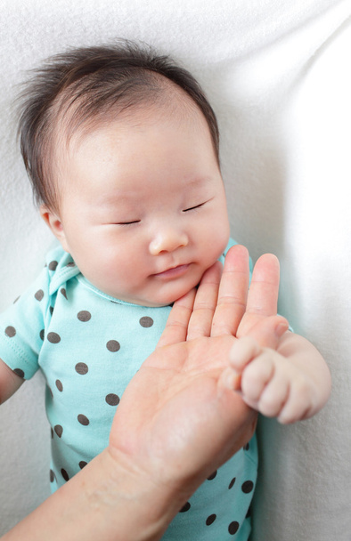 Baby sleep and mother touch her face - 写真・画像