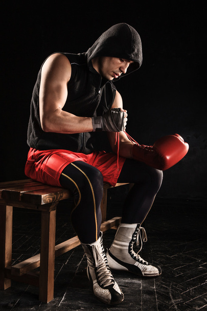The young  man kickboxing lacing glove - Фото, изображение