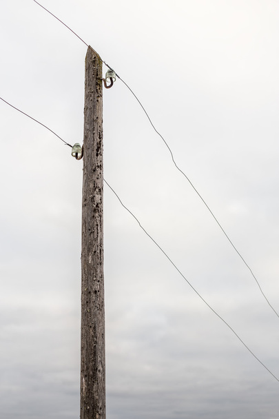 old wooden electric pole with wires  - Photo, image
