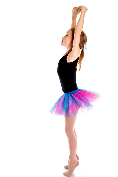 Little ballerina in purple skirt standing on white background - Zdjęcie, obraz
