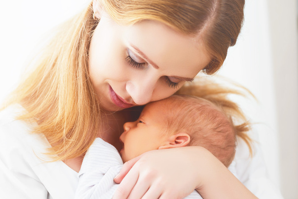 newborn baby in tender embrace of mother - Zdjęcie, obraz