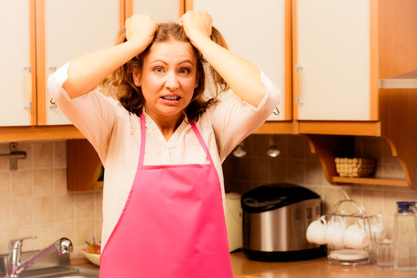 Unhappy housewife in kitchen - Фото, зображення