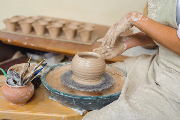 hands of a potter, creating an earthen jar on the circle - Valokuva, kuva