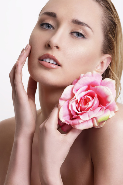 Beauty blonde young woman showing a fresh flower on white - 写真・画像