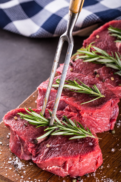 Steak. Raw beef steak. Fresh raw Sirloin beef steak sliced o Herb - Rosemary decoration - Photo, image
