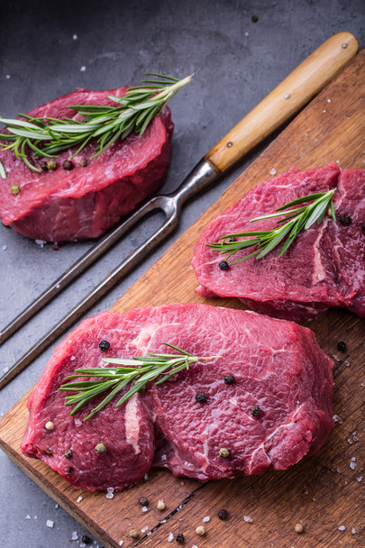 Steak. Raw beef steak. Fresh raw Sirloin beef steak sliced o Herb - Rosemary decoration - Fotografie, Obrázek