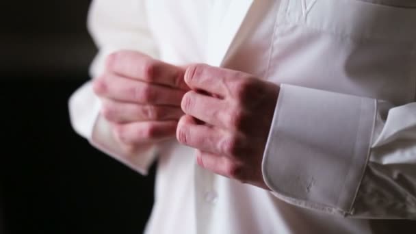 Young groom in a white shirt getting ready for a wedding ceremony and best day of his life. - Filmati, video