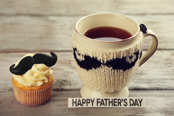 Happy fathers day special cupcake and cup of tea on wooden table - Photo, Image