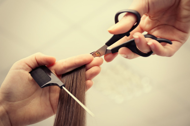 hairdresser cutting hair - Фото, изображение