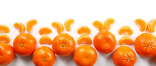 Colorful orange tangerines with slices   isolated on a white background, top view - Фото, изображение