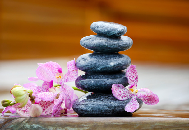 Stack of spa stones with orchids  - Foto, Bild