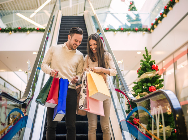 Loving couple doing Christmas shopping together - Fotografie, Obrázek