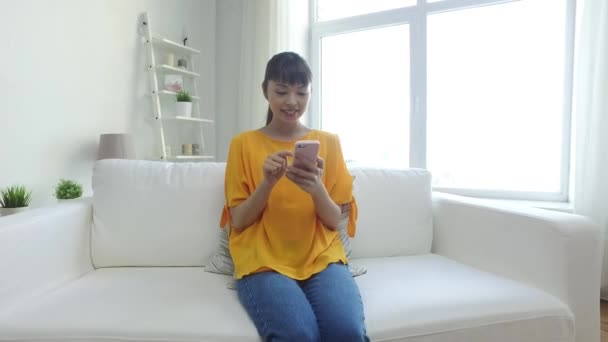 happy asian woman with smartphone at home - Imágenes, Vídeo