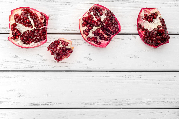 Pomegranate on table - Фото, изображение