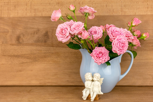 Pink flowers in blue jug. - Photo, Image