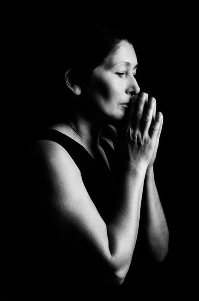Žena se modlí na černém pozadí - Fotografie, Obrázek