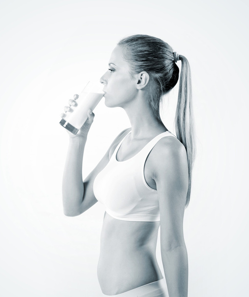 Young woman drinking milk - Valokuva, kuva