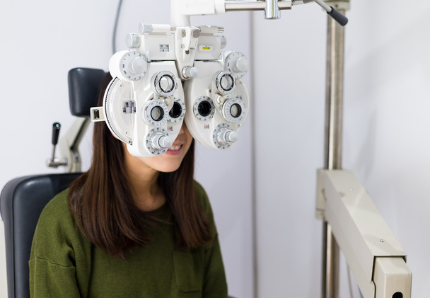 Woman checking vision at eye clinic - Fotoğraf, Görsel