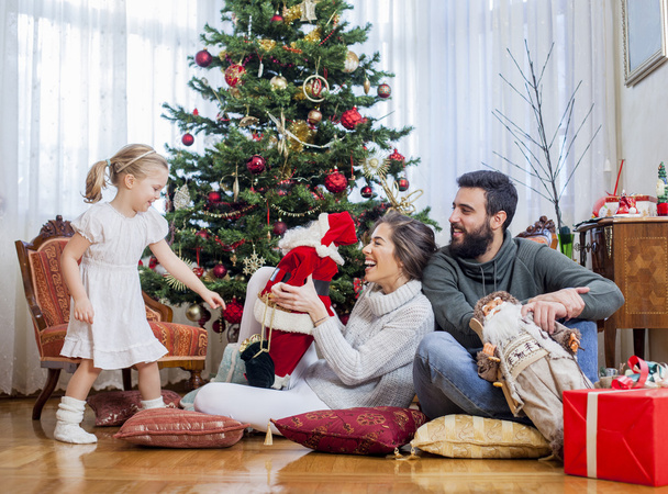 Happy family in front of Christmas tree - Photo, image