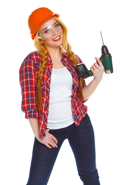 Female construction worker in a helmet with a perforator - Φωτογραφία, εικόνα