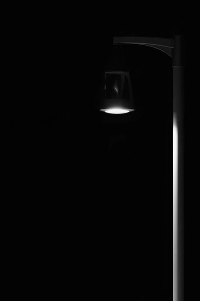 Bright Lit Outdoor Lantern Lamp Pole Post, Lonely Concept Solitude Metaphor, Illuminated Window Light, Vertical Deserted Night Park Scene Closeup, Black Isolated Copy Space Background - Foto, afbeelding