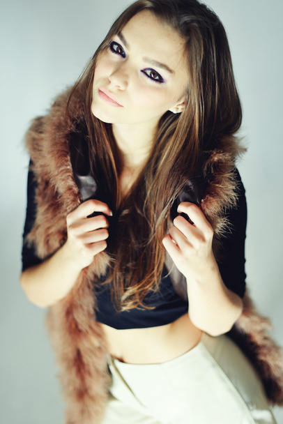 Portrait of attractive stylish woman in fur against grey background. - 写真・画像