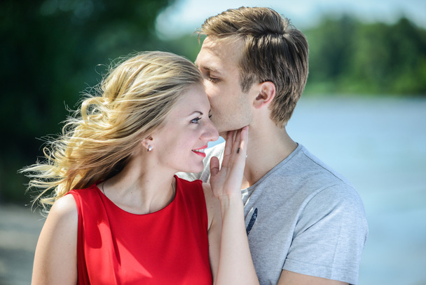 Young happy couple hugging and laughing on river background - Fotografie, Obrázek