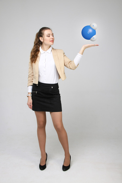 Young woman scientist with model of water molecule. - Foto, Imagen
