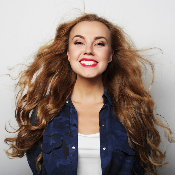 Portrait of a pretty smiling young curly woman - Zdjęcie, obraz