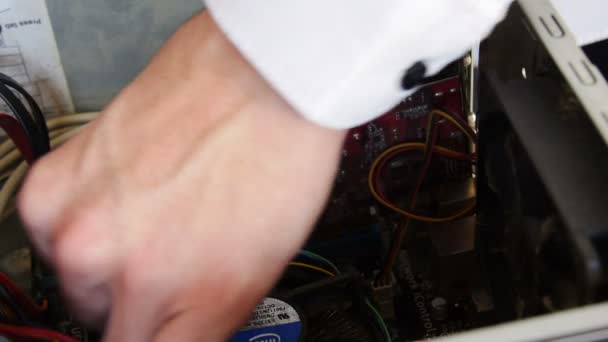 Hands of IT man removing graphical card of the motherboard of a computer - Footage, Video