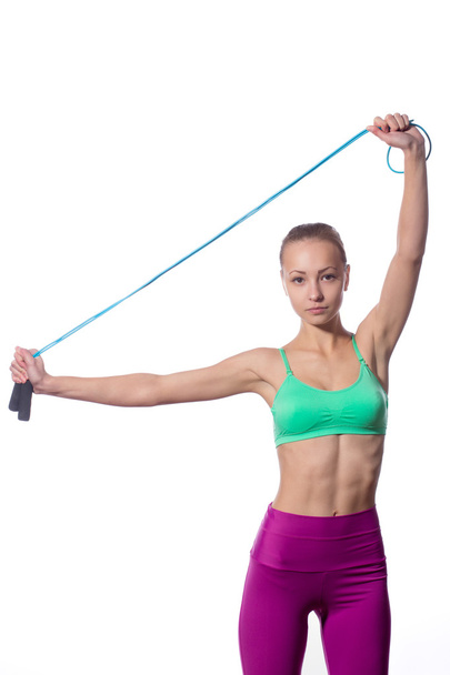 young woman with healthy sporty figure holding skipping rope - Fotografie, Obrázek