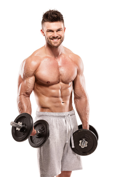 Muscular bodybuilder guy doing exercises with big dumbbell - Photo, Image