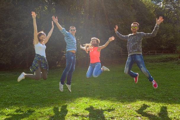Groupe d'amis s'amuser et sauter à la journée ensoleillée idyllique
 - Photo, image