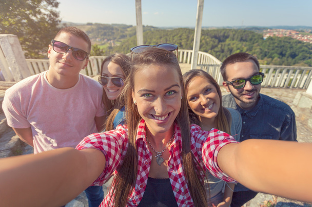Jóvenes amigos divirtiéndose y tomando selfie al aire libre
 - Foto, imagen