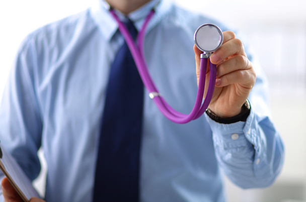 Closeup portrait of a  doctor with stethoscope holding folder - Photo, Image