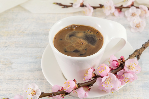 Cup of coffee with cherry blossom flowers - Photo, image
