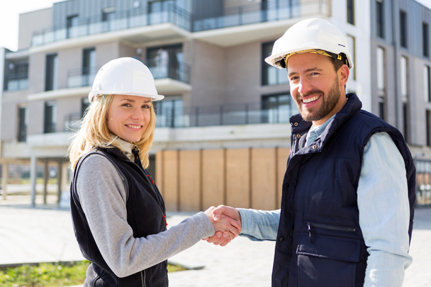 architect and worker handshaking on construction site  - Fotó, kép