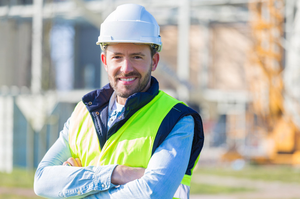 Portrait of an attractive worker on a construction site  - Fotó, kép